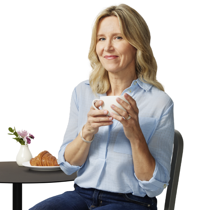smiling woman enjoying a cup of coffee